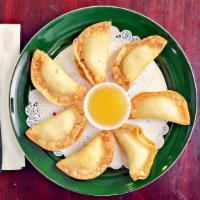 Crab Rangoon · A mixture of crab meat and cream cheese in crispy dough and pineapple sauce. Seven pieces.