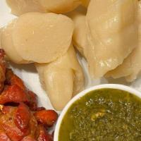 Pork Skewers & Kwanga · Grilled pork skewers come with a side of kwanga (fermented yucca) and pondu (cassava leaves)
