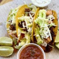 Tacos · Served with sour cream and salsa.