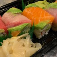 Rainbow Roll · Cut eight piece. Crabmeat, cucumber, and avocado with tuna, and white fish on top. Raw item.