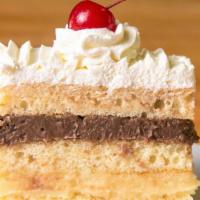 Rum Cake Slice · Sponge cake soaked in artificial rum with layers of fresh homemade whipped and vanilla and c...