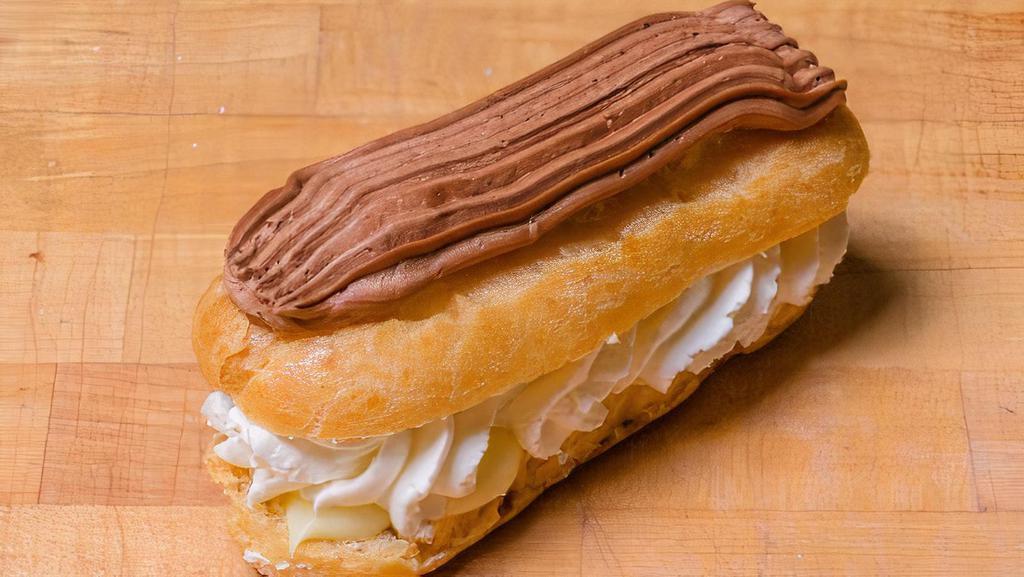 French Eclair · Puff pastry filled with creamy Italian custard and homemade fresh whipped cream topped with chocolate frosting.