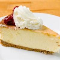 Strawberry Cheesecake Slice · New York style cheesecake topped with strawberry preserves and homemade fresh whipped cream.