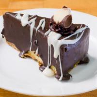 Chocolate Dipped Cheesecake Slice · New York style cheesecake dipped in chocolate and drizzled with white chocolate.