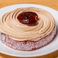 Large Mocha Round · Chiffon cake, rolled in coconut shavings, layered with raspberry preserves and topped with m...