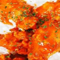 Buffalo Wings · Crispy fried chicken wingettes tossed in buffalo sauce. We fry in premium canola oil. Served...