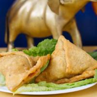 Vegetable Samosa (2 Pcs.) · Cumin flavored potatoes and peas filled in a fried pastry.  Served with sauce.