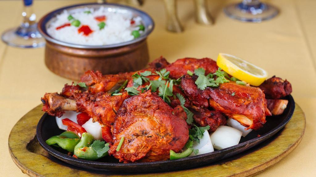 Tandoori Chicken (Half) · Chicken marinated overnight in yogurt freshly ground spices and cooked in tandoor to perfection. served with basmati rice.