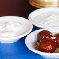 Gulab Jamun · Milk puffs deep fried and soaked in a special syrup.