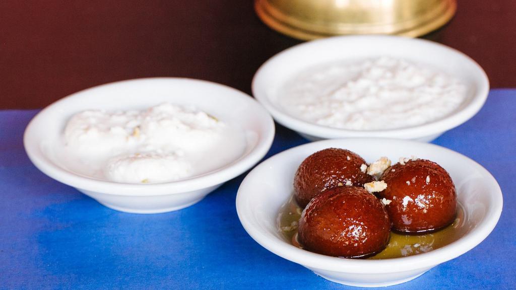Gulab Jamun · Milk puffs deep fried and soaked in a special syrup.