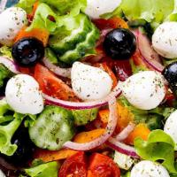 Greek Salad · Romaine lettuce, feta cheese, cherry tomatoes cucumber, carrot, onions, olives.