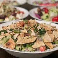 Fattoosh Salad · Chopped lettuce, parsley, tomatoes, cucumbers, and sumac. Topped with toasted pita bread.