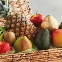 Tropical Fruit Basket · A beautiful arrangement of fresh tropical fruit delivered in a unique basket with a bow of y...