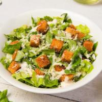 Caesar Salad · Fresh greens topped with romano cheese and herb croutons with a side of caesar dressing.