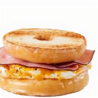 Inside Out Glazed Donut Breakfast Sandwich · Fresh cracked egg, smoked ham, and cheddar cheese on a glazed donut cut in half “bagel style”
