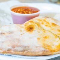 Calzone · Filled with ricotta, mozzarella cheeses, and ham.