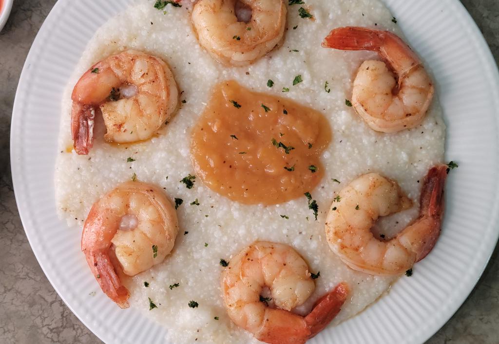 Shrimp & Grits · Creamy grits topped with sauteed shrimp and café sauce.