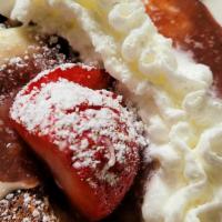 French Toast Casserole · Garnished with powdered sugar and strawberry. Served with bacon or sausage.