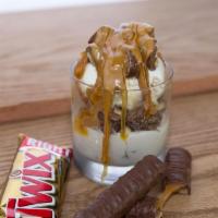Great White Buffalo · Vanilla ice cream topped with chopped twix, caramel and chocolate syrup and peanut butter sh...