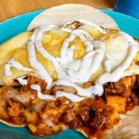 Nachos · Corn tortillas topped with sauteed chicken, chorizo sausage, beans, corn, two baked eggs, ch...