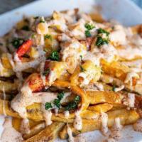 Lobster Fries · Fresh poached lobster meat sauteed with cajun cheese sauce over a bed of cajun hand cut fries