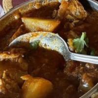 Lamb Vindaloo · Tender pieces of lamb cooked with potatoes, hot spices and fresh green herbs.