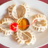 Chicken Momo (8 Pcs.) · Steamed dumplings. Served with a non-vegetarian dish with mouth watering roasted tomato chut...