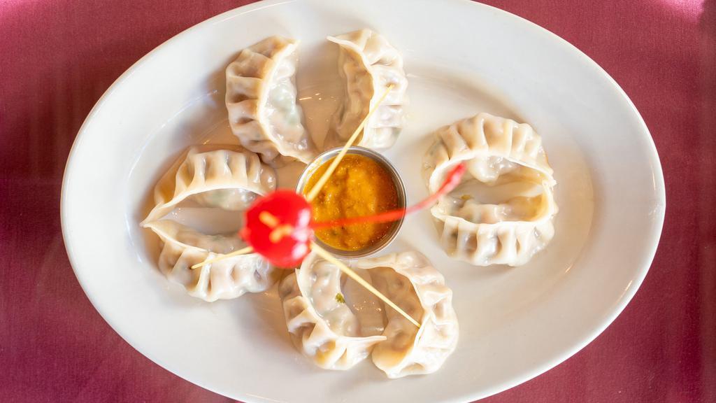 Chicken Momo (8 Pcs.) · Steamed dumplings. Served with a non-vegetarian dish with mouth watering roasted tomato chutney.