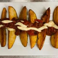 Patatas Bravas · Potato wedges, chorizo salsa brava, garlic-lemon aioli