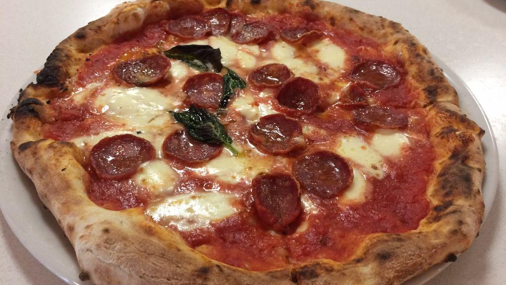 Calabria Pizza · Tomato sauce, mozzarella, spicy salami and basil.
