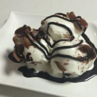 Profiteroles · Puff pastries and chocolate cream topped with white chocolate.