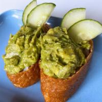 Vegan Inari Sushi · Sushi rice stuffed into simmered fried tofu pockets, topped with avocado and cucumber.