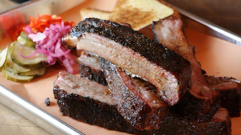 1 Lb Pork Ribs · 1 pound (approximately 4-6 ribs depending on size) served with texas toast and pickles, dry rubbed and slow smoked daily