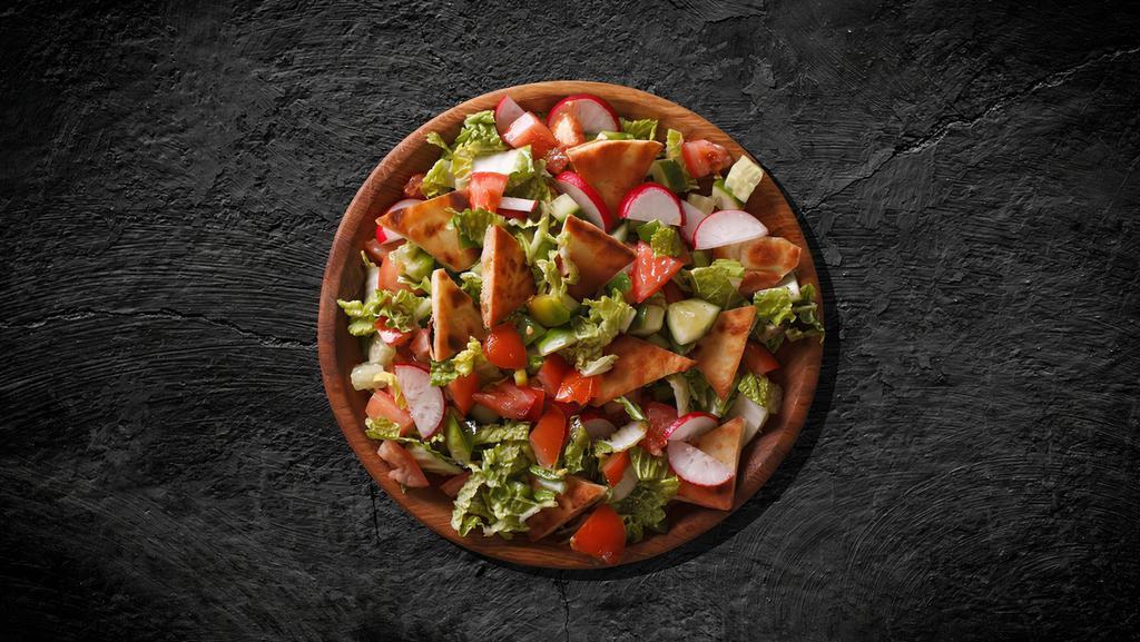 Fattoush Feast Salad · Flatbread combined with lettuce, cucumber, tomato, green pepper, onions, parsley, sumac, lemon olives oil