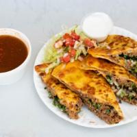 Beef Birria Quesadilla · 12 inch flour tortilla wrap stuffed with cheese, onions, cilantro, meat.
1 side beef consome.