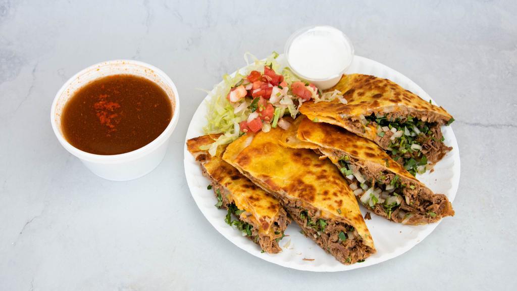 Beef Birria Quesadilla · 12 inch flour tortilla wrap stuffed with cheese, onions, cilantro, meat.
1 side beef consome.