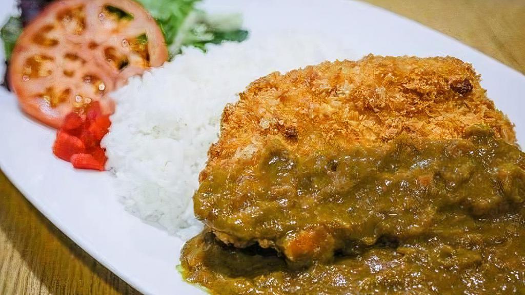 Chicken Cutlet Curry · Lightly breaded chicken cutlet served Japanese curry over rice with side of pickle relish and Salad topped with ginger dressing.