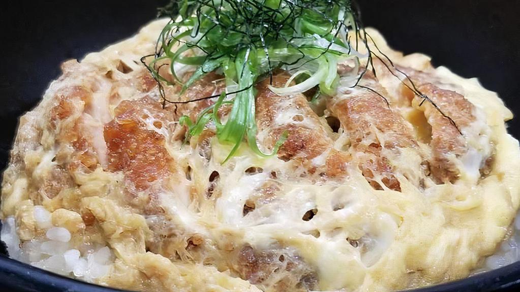 Pork Katsudon · Lightly breaded pork cutlet, egg, caramelized onions, and scallions served with sweet soy dashi over rice.