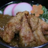 Karaage Curry Udon · Fish broth and udon topped with chicken karaage curry, seasonal veggie, fish cake, and scall...