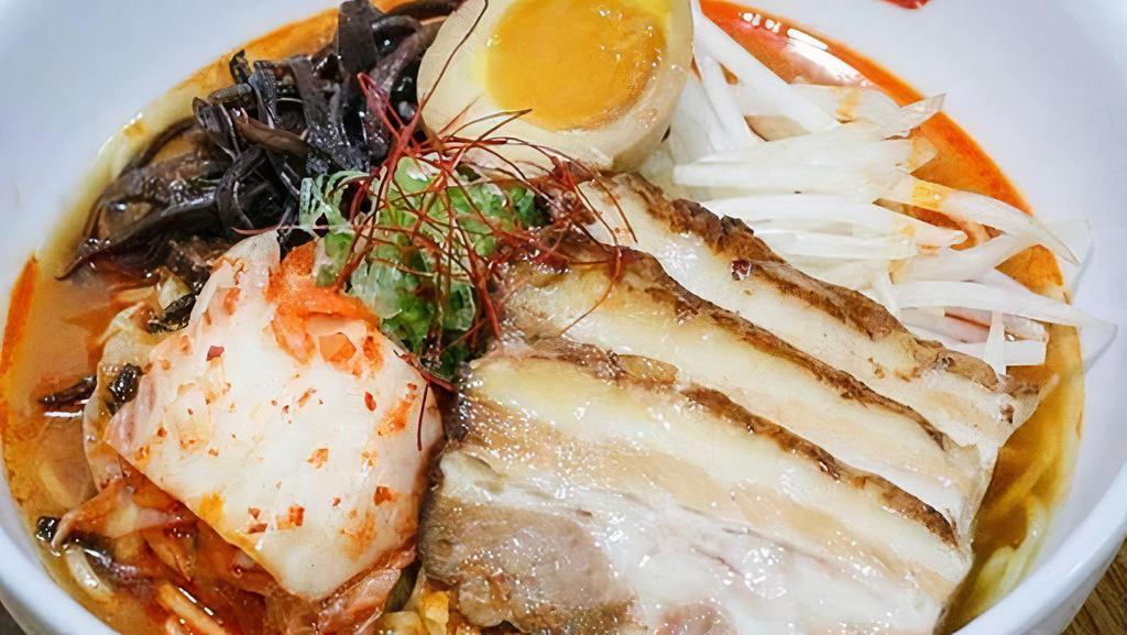 Spicy Ramen · Natural Heritage Berkshire Pork bone soup (tonkotsu) with chicken and seafood broth with wavy egg noodle topped with roast pork (charshu), kimchee, kikurage mushroom, bean sprout, scallion, and seasoned boiled egg.