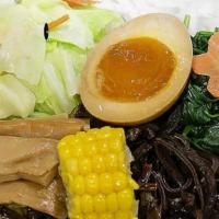Veggie Shoyu Ramen · Vegetable broth (shoyu base) with wavy egg noodle topped with cabbage, carrot, seasonal vegg...