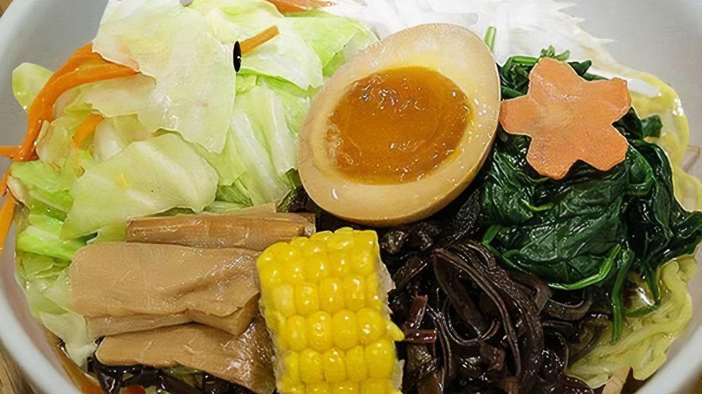 Veggie Shoyu Ramen · Vegetable broth (shoyu base) with wavy egg noodle topped with cabbage, carrot, seasonal veggie, bamboo shoot, corn, kikurage mushroom, bean sprout scallion, sesame seed, and seasoned boiled egg.