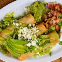Chicken Flautas Plate · Lettuce and guacamole on top.