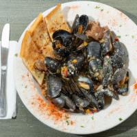 Mardi Gras Mussels · Andouille sausage, mixed peppers, spicy white wine sauce.
