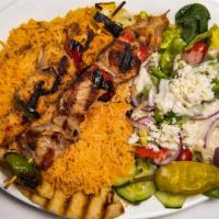 Santorini Deluxe (Souvlaki Deluxe) · Grilled chicken and pork over rice with a side of tzatziki sauce and salad.