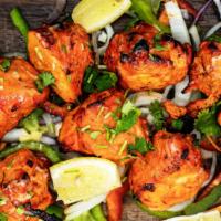 Chicken Tikka · Boneless chicken marinated in spices and baked in Tandoor (clay oven). 

Served with Basmati...