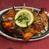 Tandoori Chicken · Half Chicken (Leg & Breast) marinated in spices and baked in Tandoor (Clay oven).

Served wi...