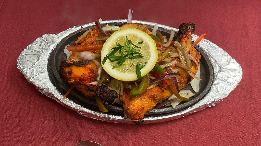 Tandoori Chicken · Half Chicken (Leg & Breast) marinated in spices and baked in Tandoor (Clay oven).

Served with Basmati Rice.