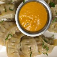 Chicken Or Pork Mo:Mo (Dumpling)  · Minced chicken mixed with Nepali spices and steamed inside a flour dough shell, served with ...