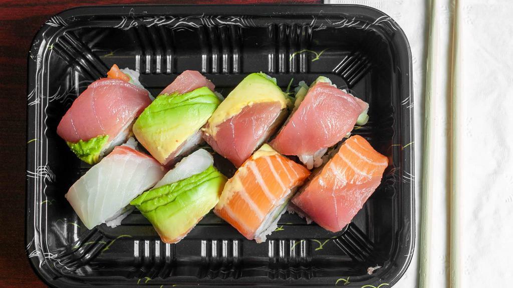 Rainbow Roll · Crab stick and cucumber inside, topped with tuna, salmon white fish and avocado.